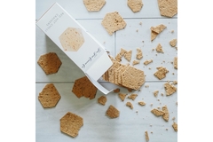 Image Crackers spilling out of a box, broken.